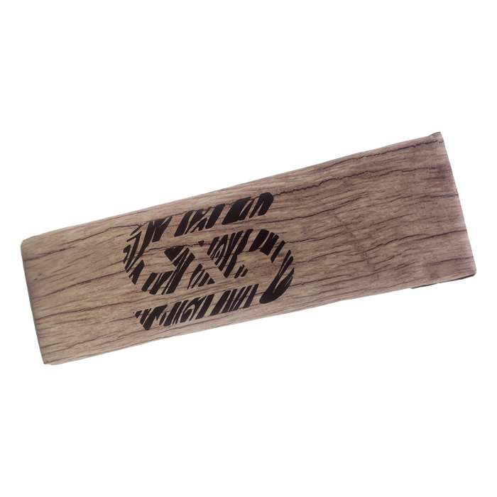Rectangular woodchip fire log with natural grain texture and a black stylized logo printed on top.